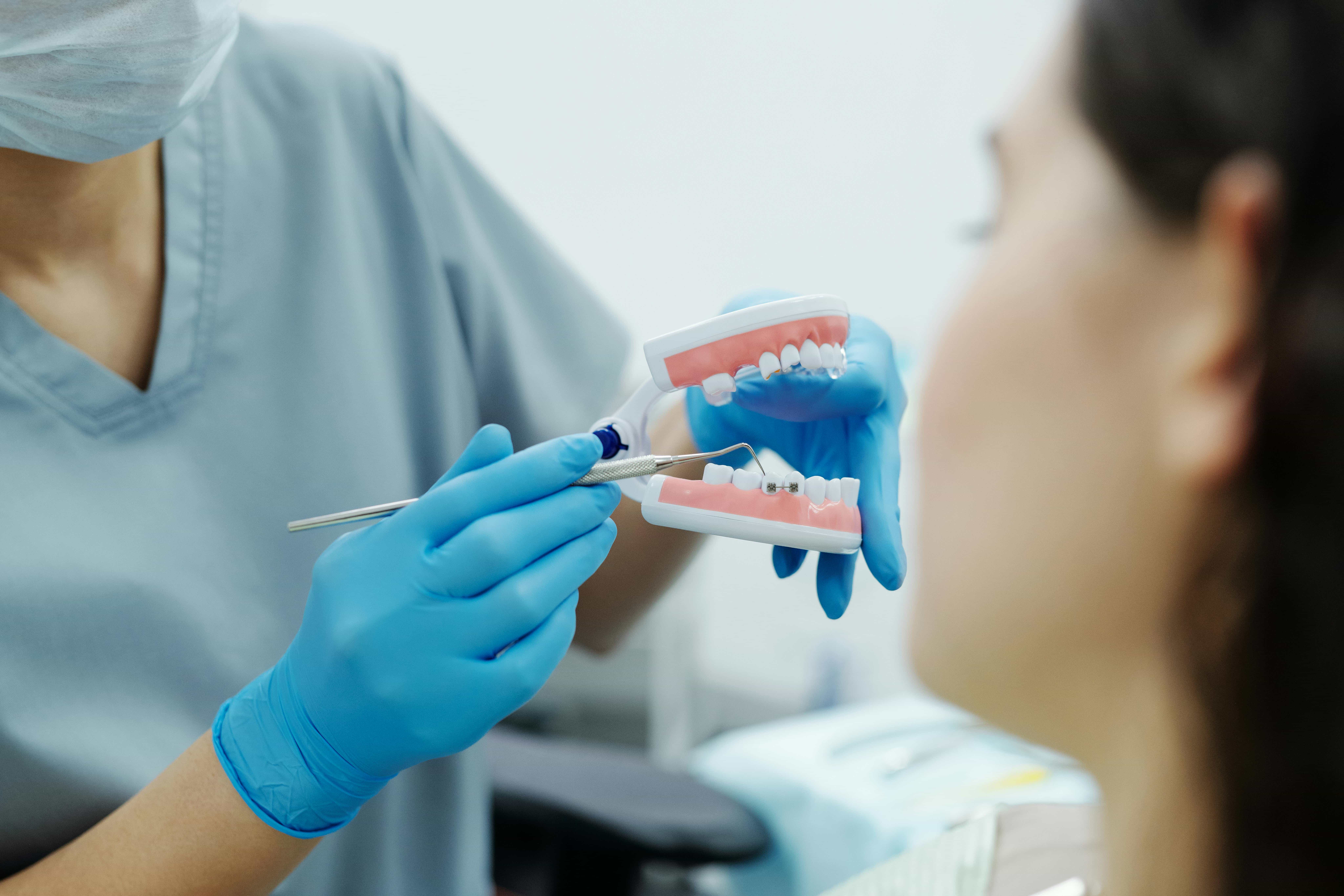 orthodontist showing braces to patient